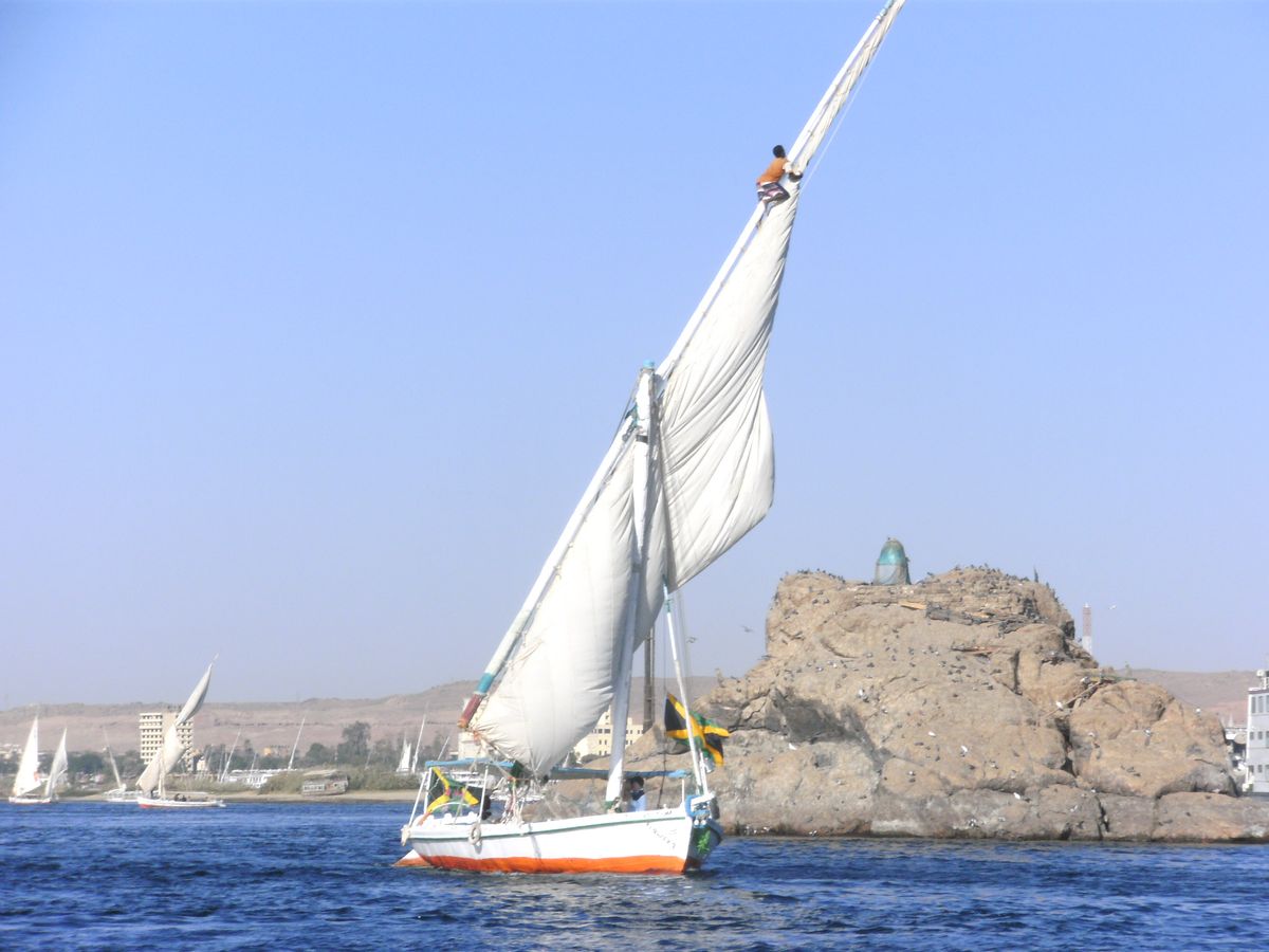 A man climbing the mast of his boat in Egypt