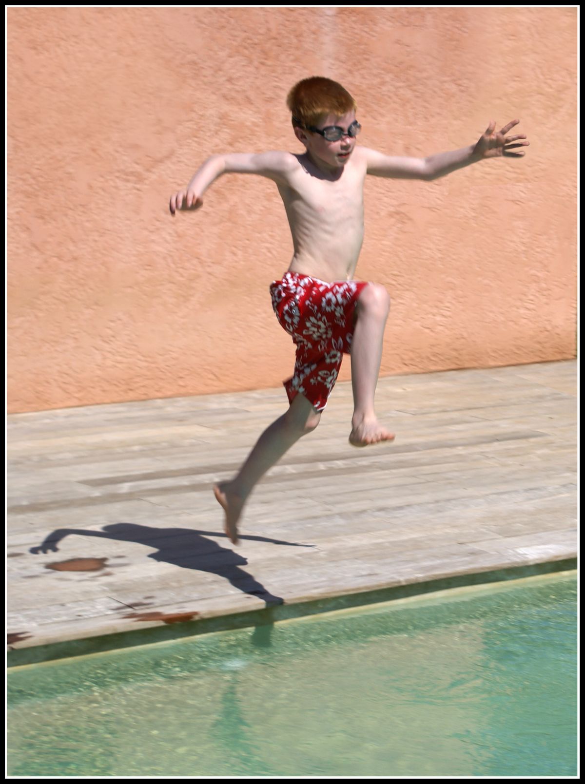 Action picture of my son leaping into a pool