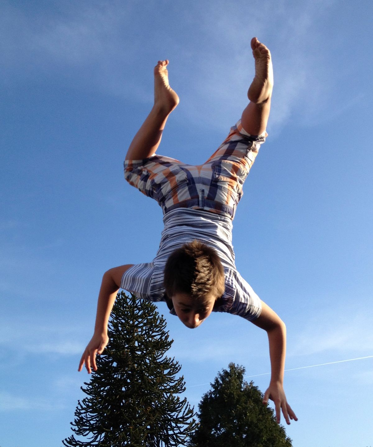 This boy enjoys his trampoline. 