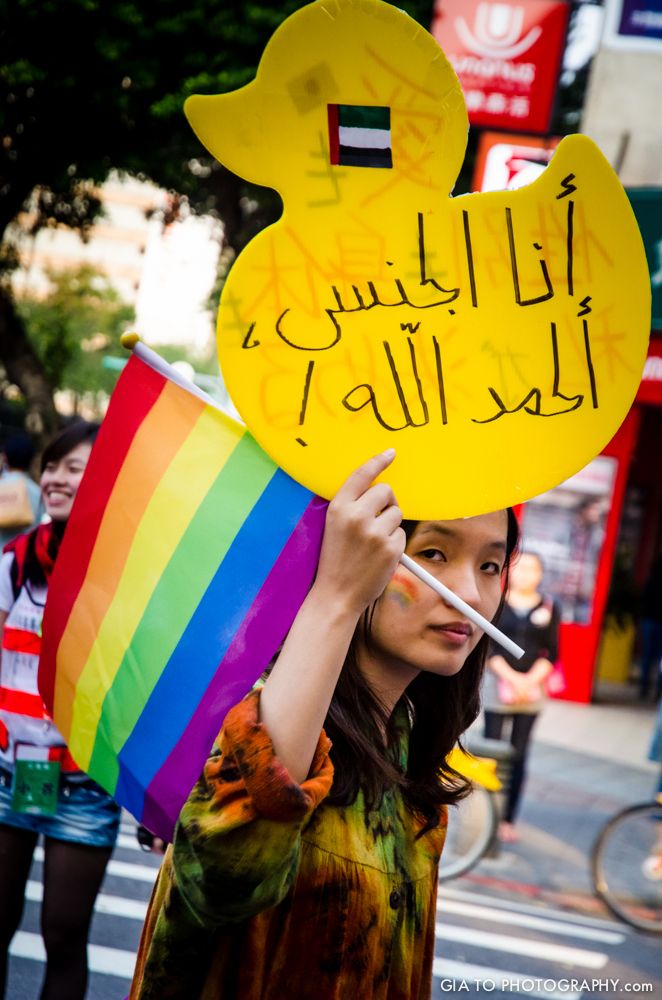 Woman fighting for the LGBT rights in Taiwan during the Gay Pride, the biggest one in Asia. I was caught by the intensity of the look of that woman, then I realized that her cause was more than fighting for same sex marriage. In the United Emirates of Arabia (the country of the flag on her sign board), being homosexual can be punished by death penalty.